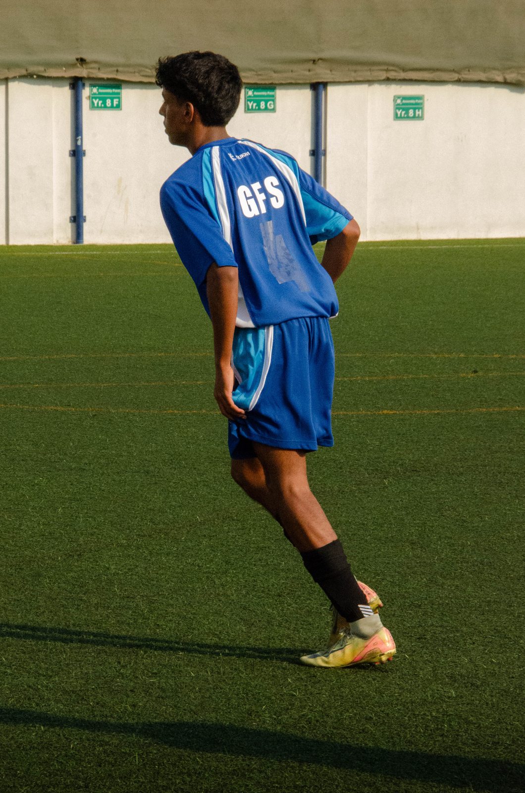 Dev scanning the pitch in his blue GFS football kit